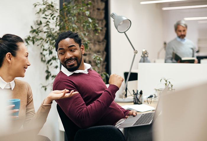 Two business people taking in an office